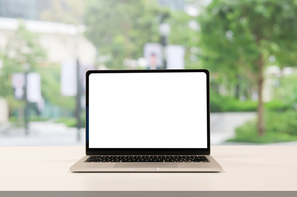 办公楼内桌上的笔记本电脑空白屏幕特写，背景为花园景象，可用于设计横幅、网站、模板或在线购物电商概念的添加内容图片下载