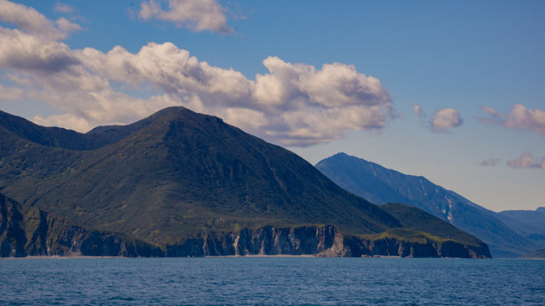 背景为山地地形的广阔水域，天空部分多云图片下载