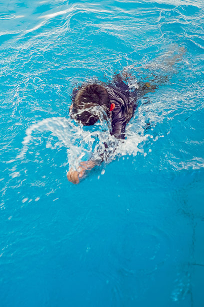 俯视角度拍摄的照片，捕捉到一个无法辨认身份的人沉浸在清澈的蓝色之中图片下载