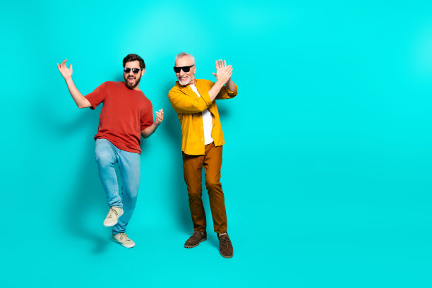 快乐的朋友们一起跳舞，两位穿着多彩休闲装的男士正在为生活方式照片摆姿势图片下载