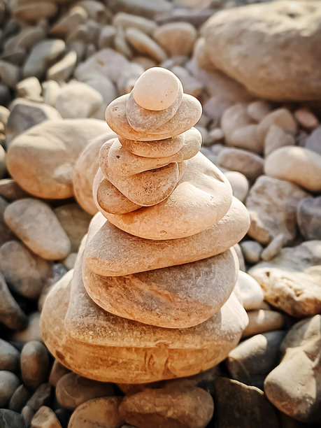 海边海边鹅卵石塔。平静的背景，垂直照片。图片下载