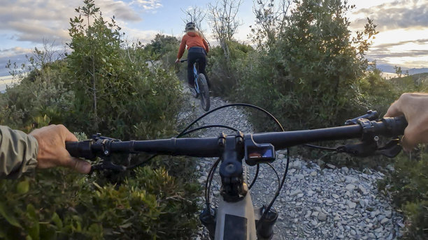 第一人称视角，跟随年轻女子骑行电动山地自行车图片下载