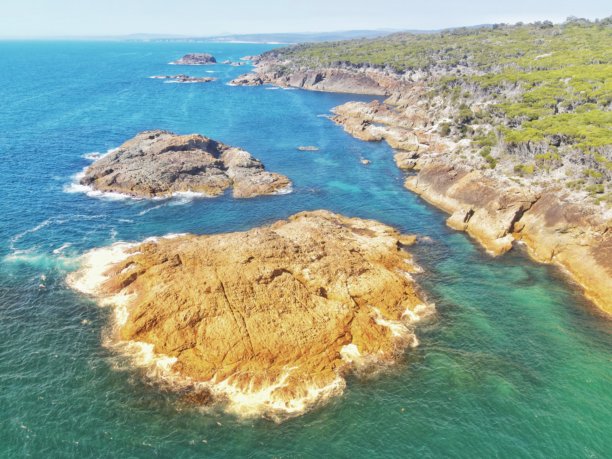从空中俯瞰，南太陆地塔拉附近布隆达国家公园内美丽的岩石海岸线和海滩。该照片沿著通往梅里姆布拉码头的金加鲁塔步行道拍摄。新南威尔士州蓝宝石海岸。图片下载