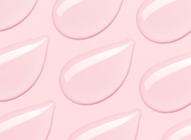 粉色背景上的透明凝胶精华滴图片下载