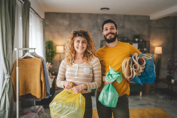 夫妻在家回收垃圾，分类处理塑料、纸张和玻璃图片下载