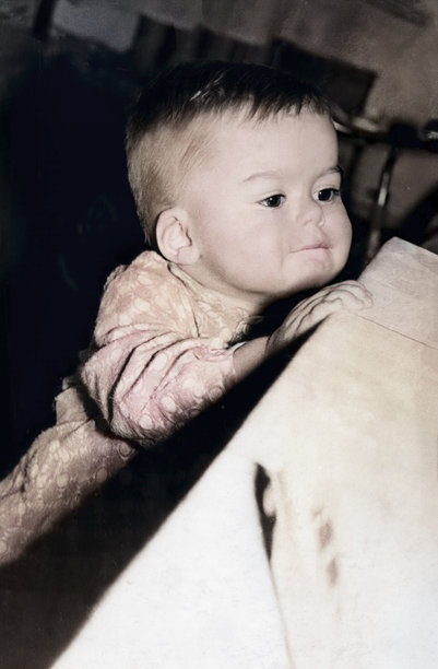 一个好奇小男孩的复古肖像，他试图够到桌子看看上面有什么。复古照片，1969年。图片下载