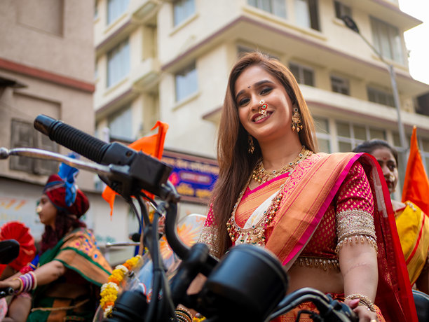 一位身着传统服饰的印度美女在孟买参加古迪帕德瓦节（印度新年）的游行时骑着摩托车图片下载