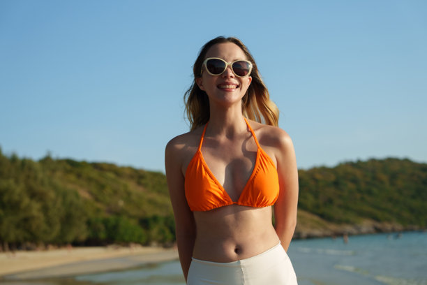 这张照片展示了一位快乐的女性在热带岛屿海滩上享受浪漫假期。图片下载