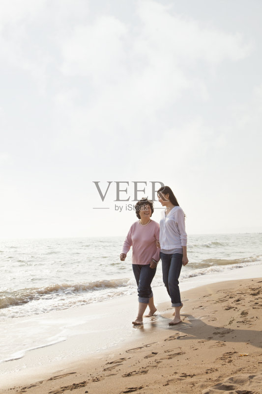 祖母和孙女在海滩边散步正版图片素材