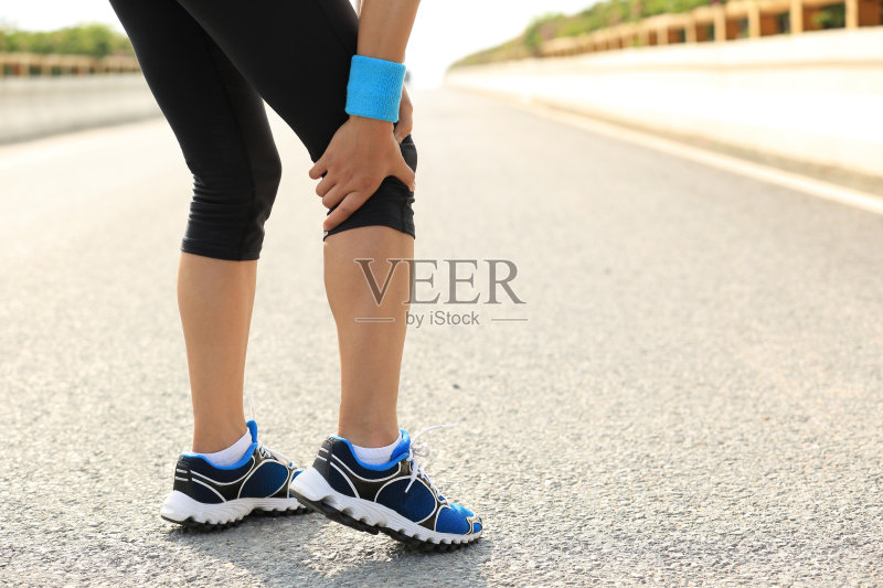 女运动员扶着她受伤的腿正版图片素材