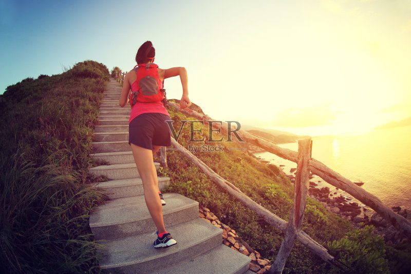 健身女跑步者在海边的山楼梯上跑步，正版图片素材