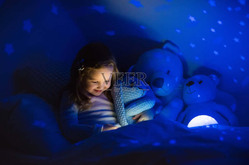 小女孩在床上看书正版图片素材