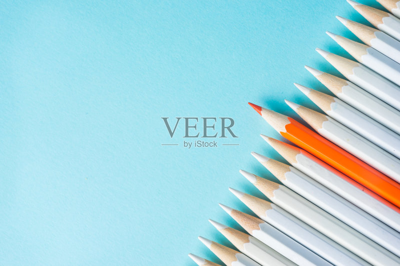 许多白色铅笔和彩色铅笔在蓝色纸的背景。正版图片素材