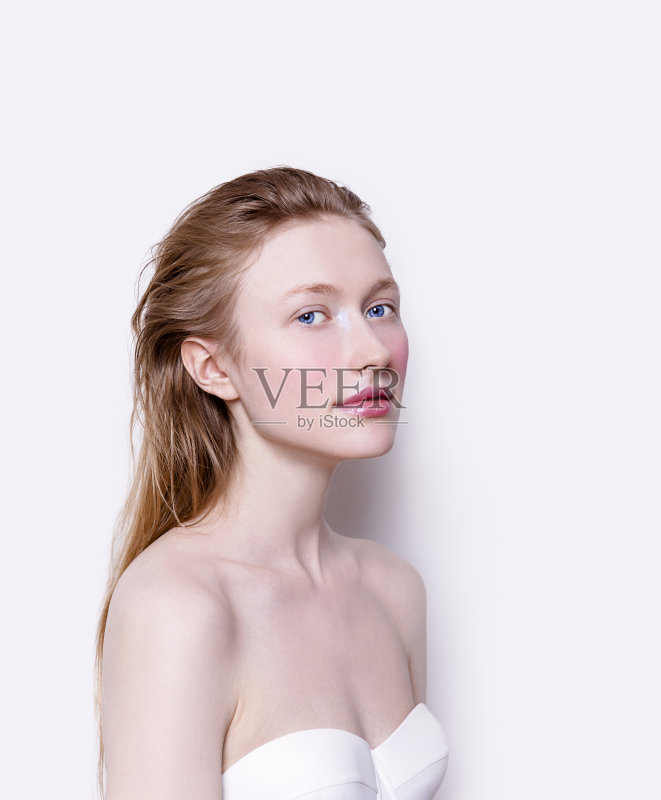 美丽的年轻女子苍白的皮肤，玫瑰的颜色，腮红和粉红色的口红正版图片素材