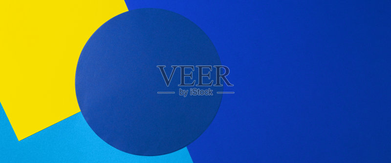 抽象彩色纸纹理背景。黄色、浅蓝色和海军蓝的最小几何形状和线条正版图片素材