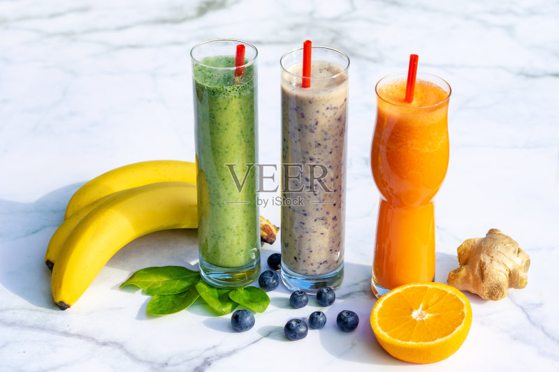 三种不同的冰沙的原料在大理石桌子背景姜香蕉蓝莓菠菜正版图片素材