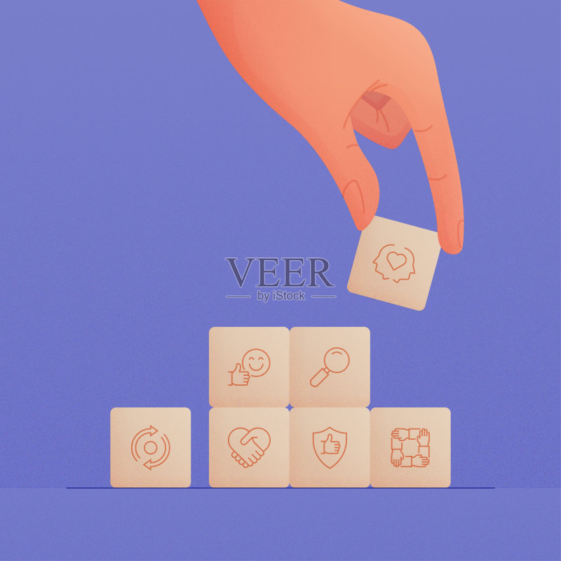 手持带有核心价值观图标的木制方块图标素材